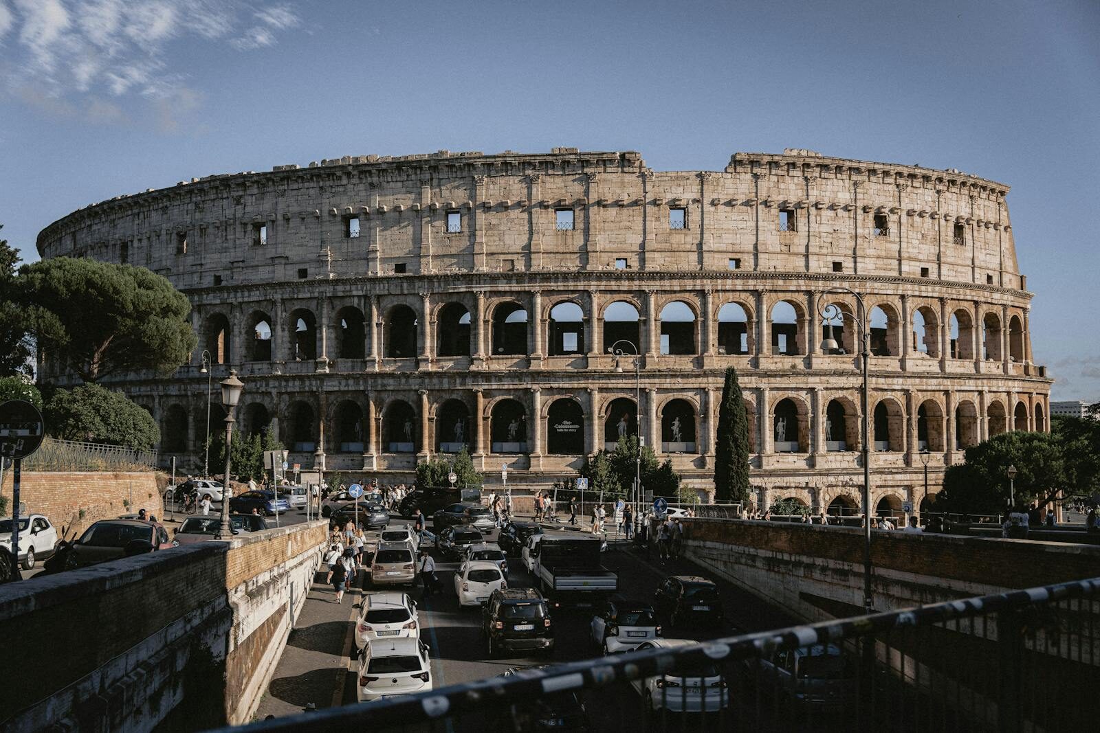 The Colosseum stands majestically amidst bustling Rome, an iconic remnant of ancient architecture.