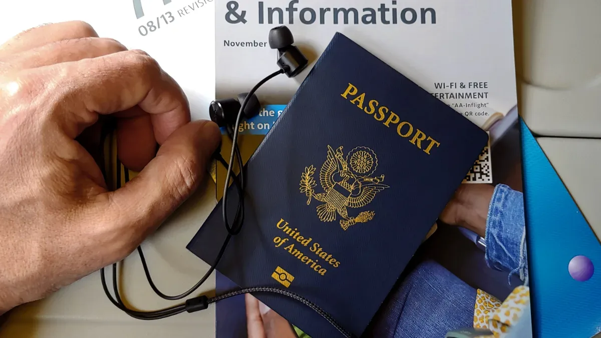 US passport on an airplane seat before a flight home from Rome